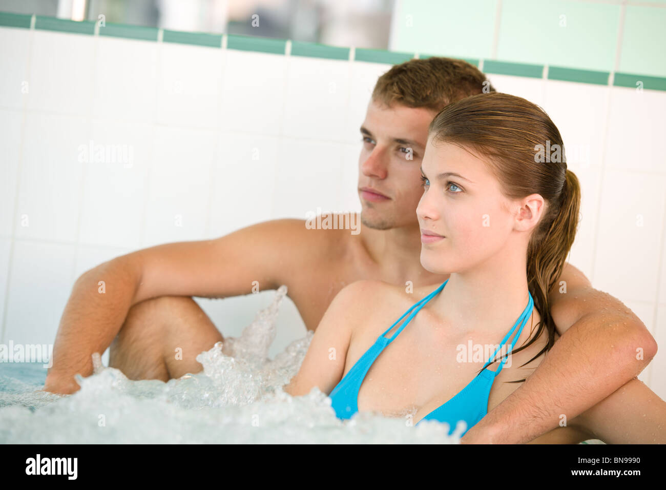 Young loving couple enjoy whirlpool bath in luxury spa Stock Photo