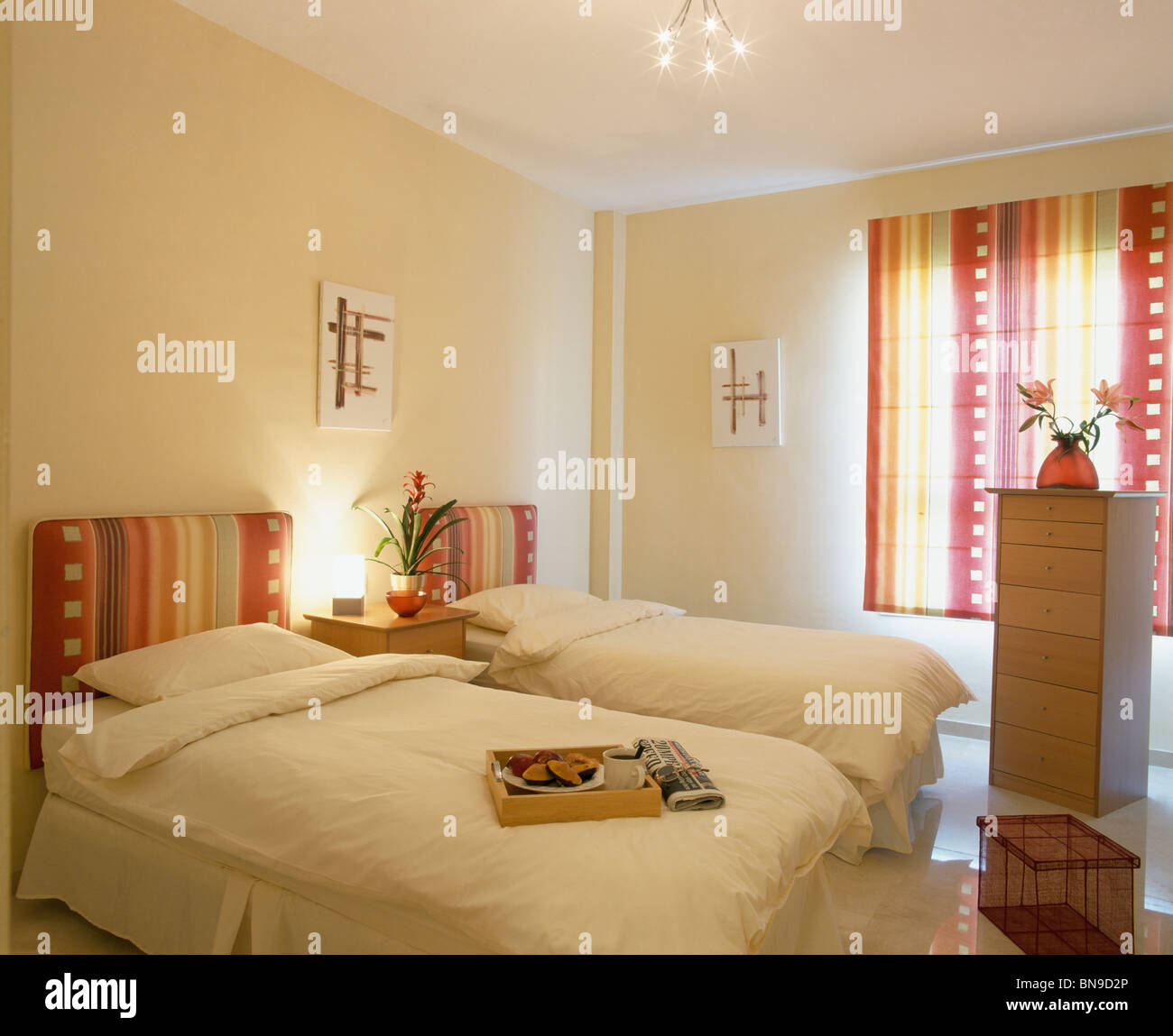 Colorful striped headboards on twin beds with white bedlinen in white