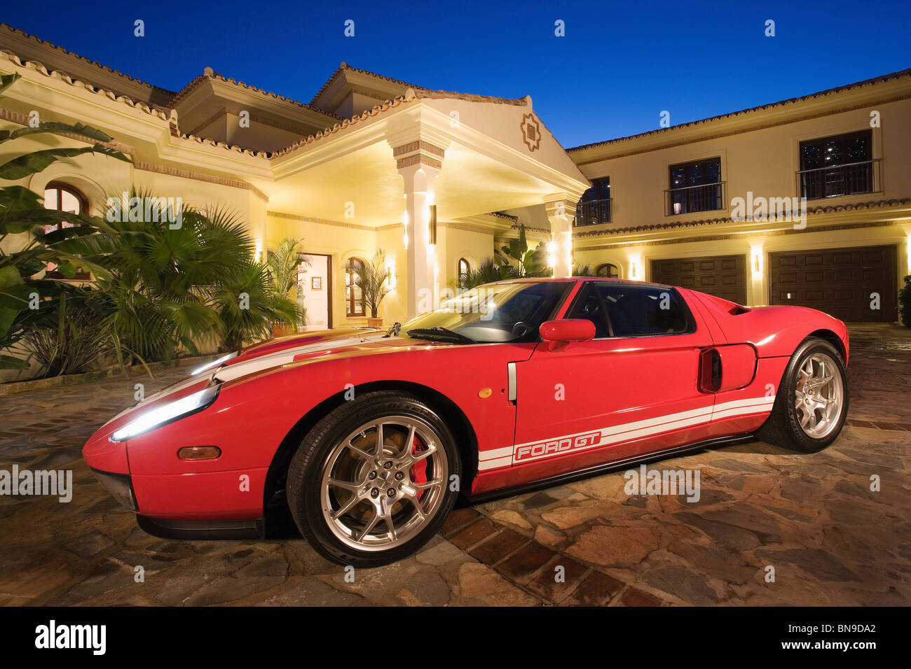 Red Ford GT sports-car in front of Spanish villa lit at night Stock Photo -  Alamy