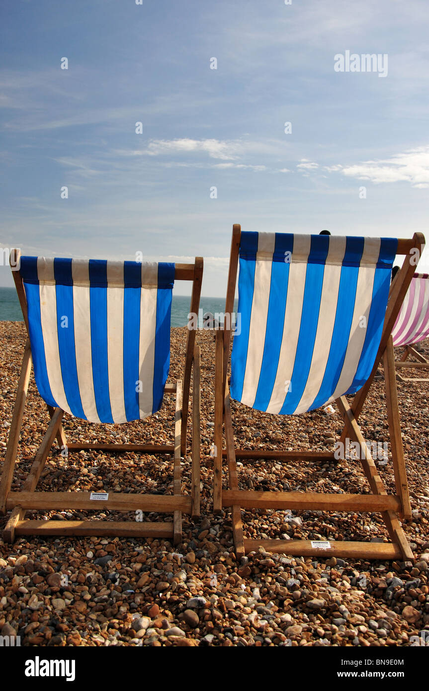 Silhouetted deck chairs on beach, Brighton, East Sussex, England, United Kingdom Stock Photo