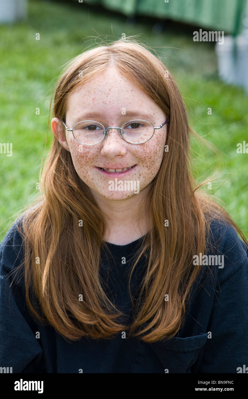 Portrait of a young red haired freckle faced girl at a farmers market in the small mountain town of Salida, Colorado, USA Stock Photo