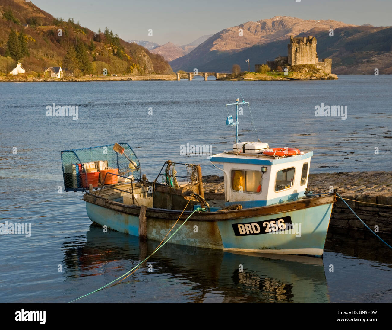 Local Fishing Boat & Eilean Donan Castle, Loch Duich, Scottish Highlands, Scotland, UK Stock Photo