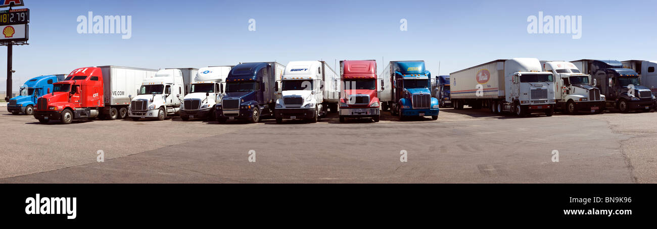 Over-the-road tractor trailer rigs parked at a Travel America truck stop, Interstate 70, Limon, Colorado, USA Stock Photo