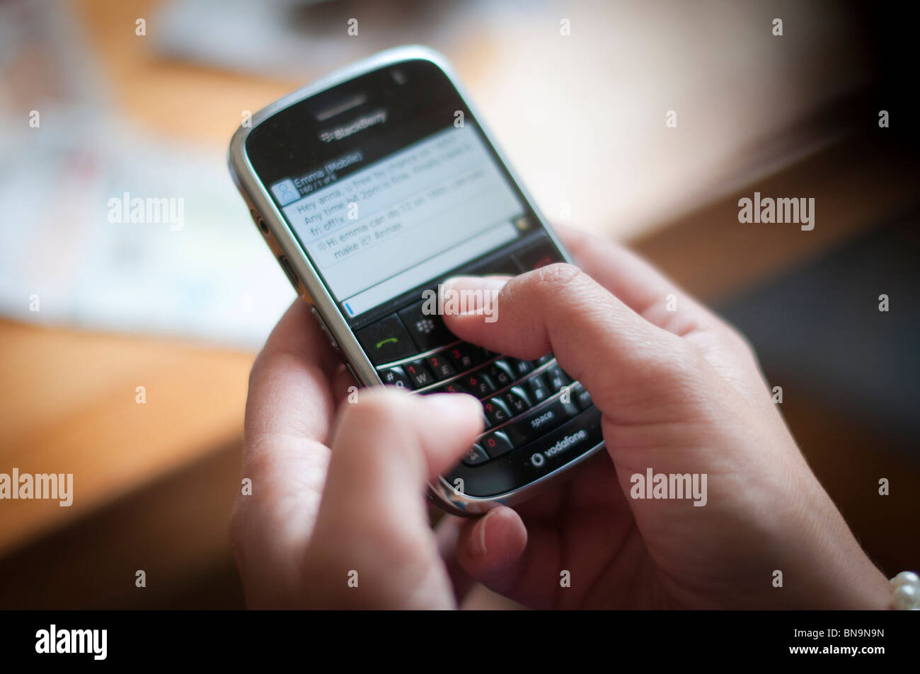 Close-up of a woman using RIM Blackberry Smart Phone Stock Photo