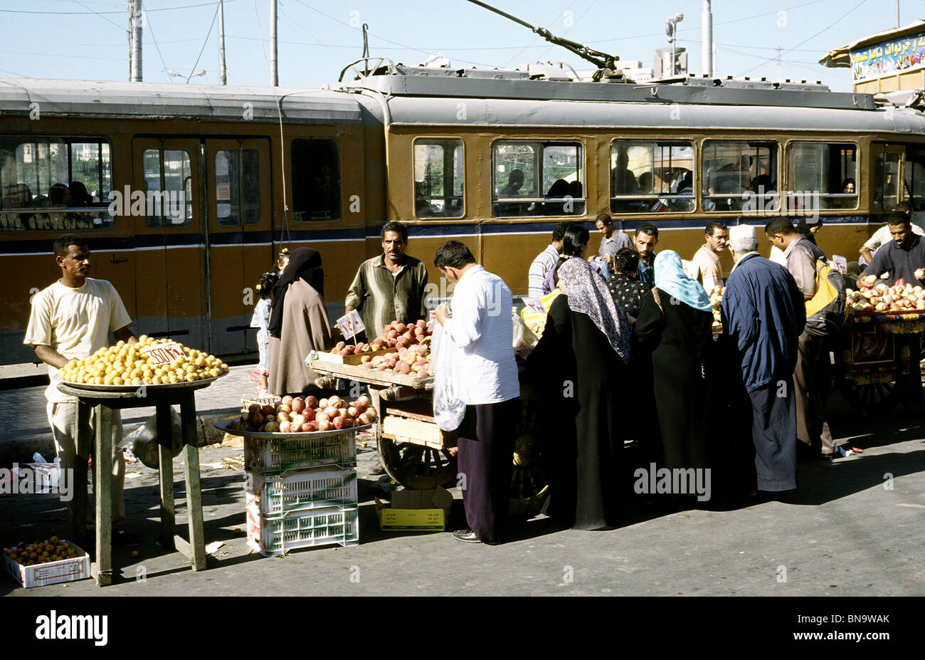 Tram pushing through the bazaar on Midan el-Gumhorriya in Alexandria. Stock Photo