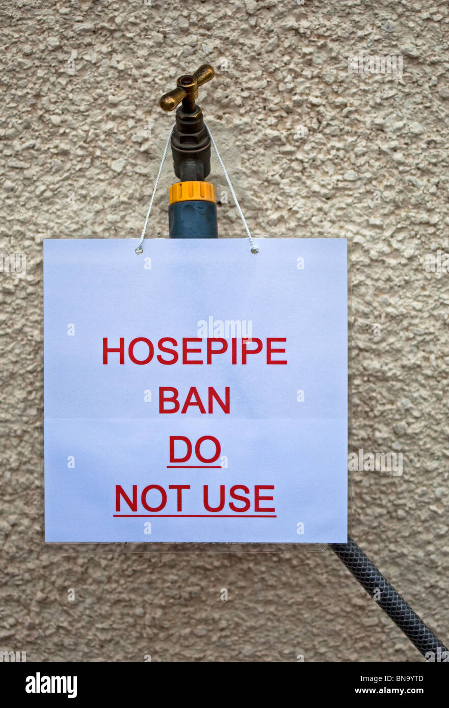 Hosepipe ban sign with notice forbidding the use of garden water hose on tap during drought UK Europe Stock Photo