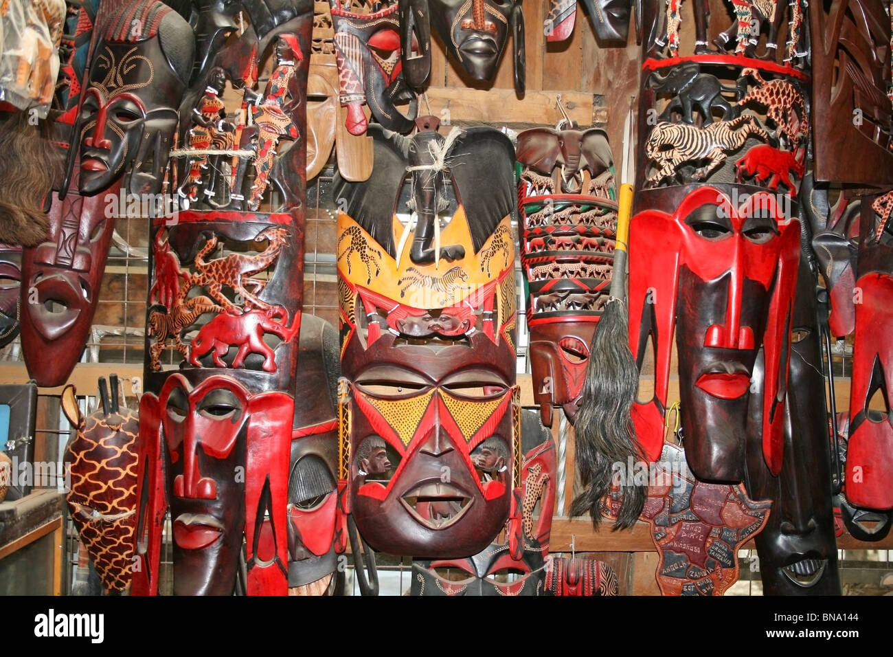 Masai wooden Masks and traditional craft items being sold at a souvenir shop near Masai Mara National Reserve Kenya, East Africa Stock Photo
