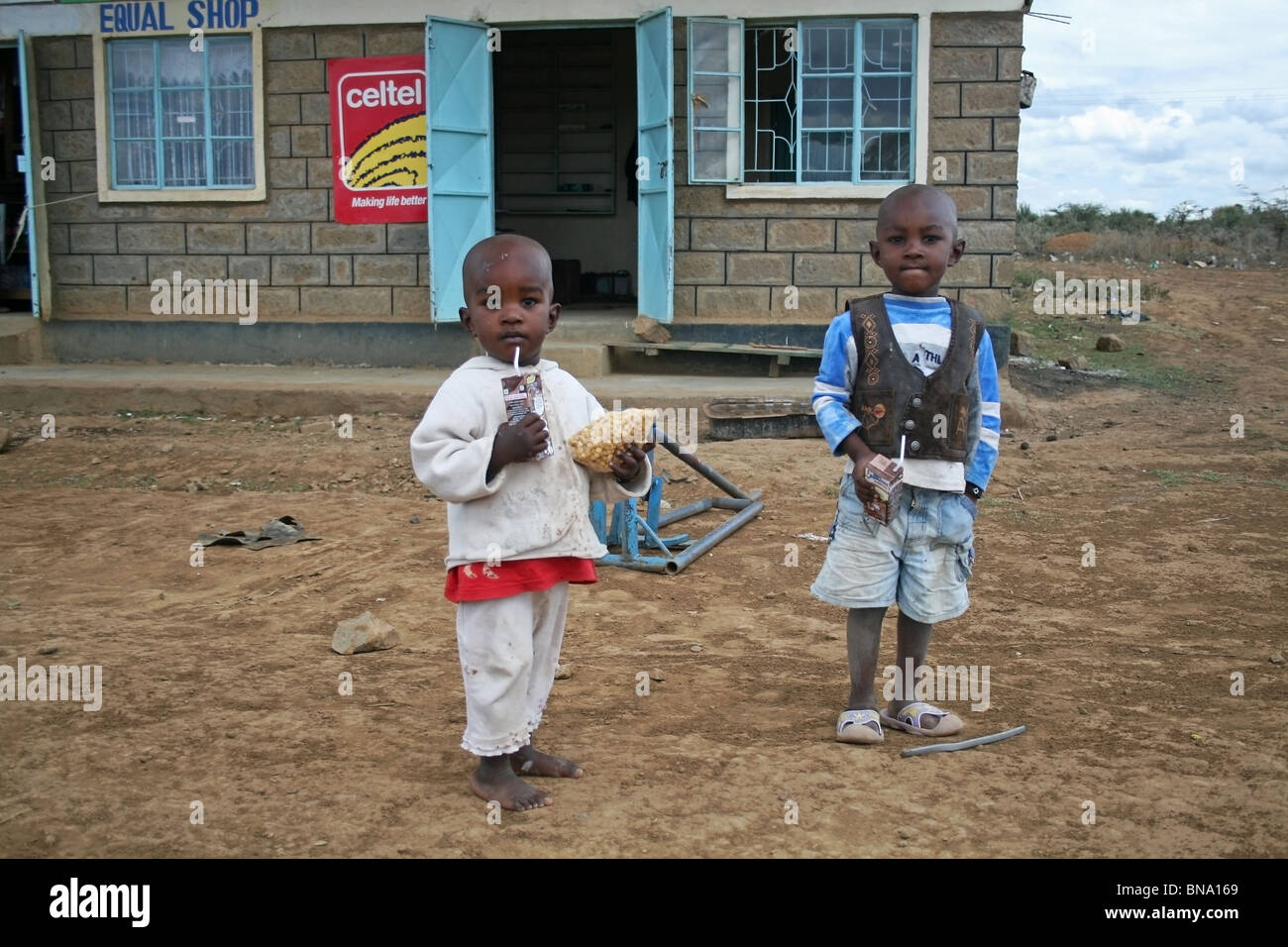 Poor street children happy after getting gifts from tourists on the highway leading to Lake Nakuru game reserve, Kenya, Africa Stock Photo