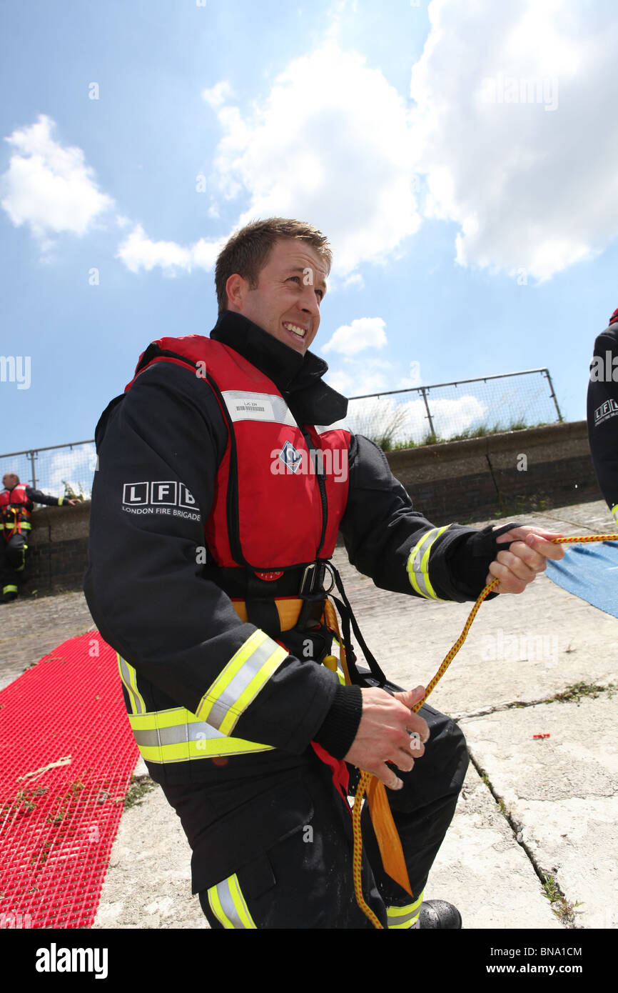 fireman training to save a person who is drowning in open water. they ...