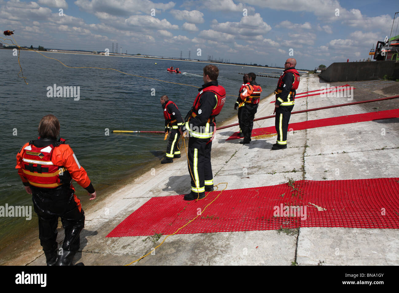 fireman training to save a person who is drowning in open water. they ...