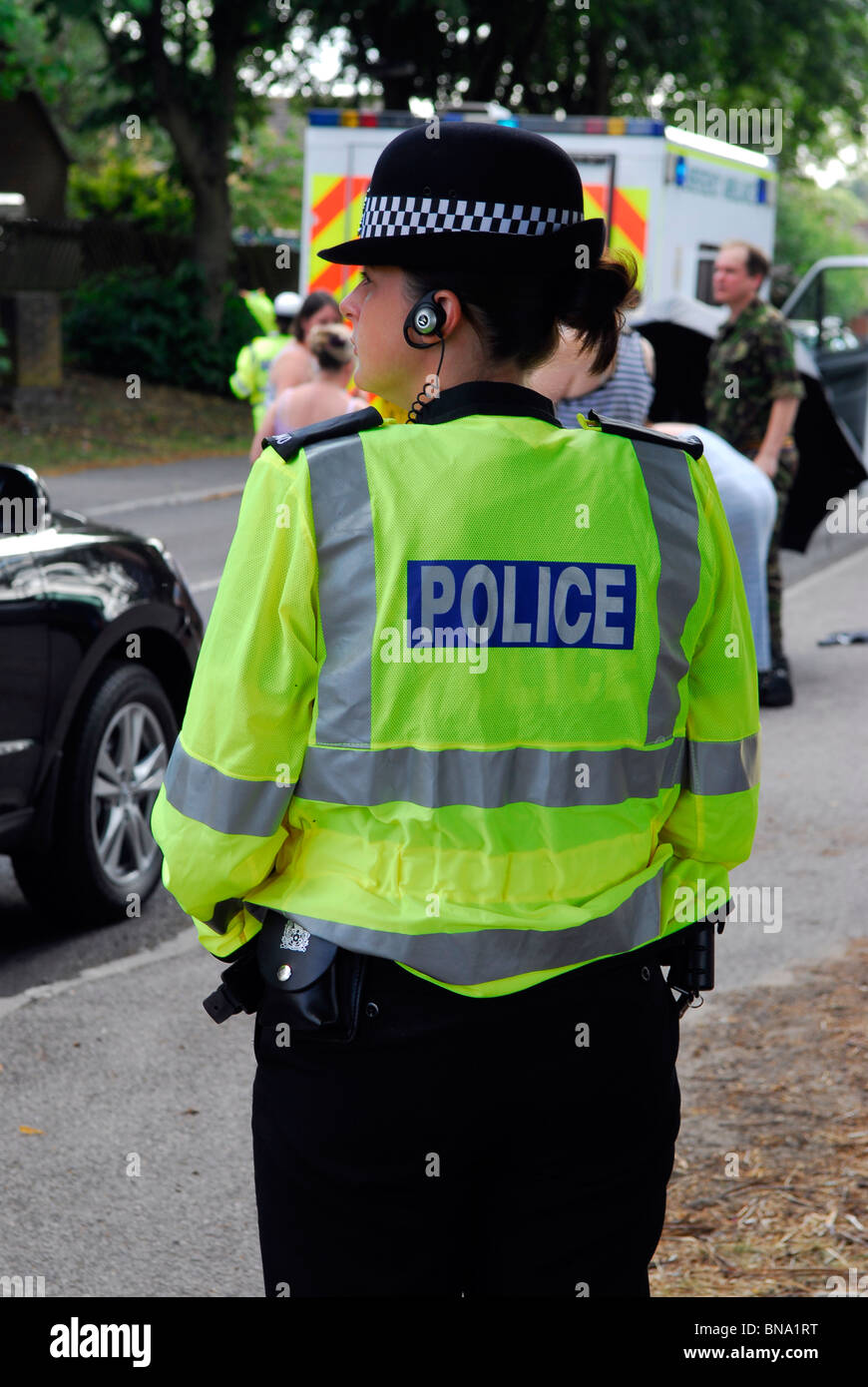 Female police officer watching over a road traffic accident, Bordon, Hampshire, UK, July 2010. Stock Photo