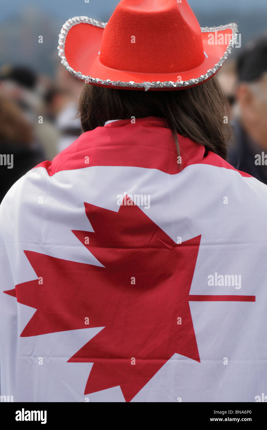 Man wearing Canadian flag at Canada Day celebrationsVictoria, British Columbia, Canada Stock