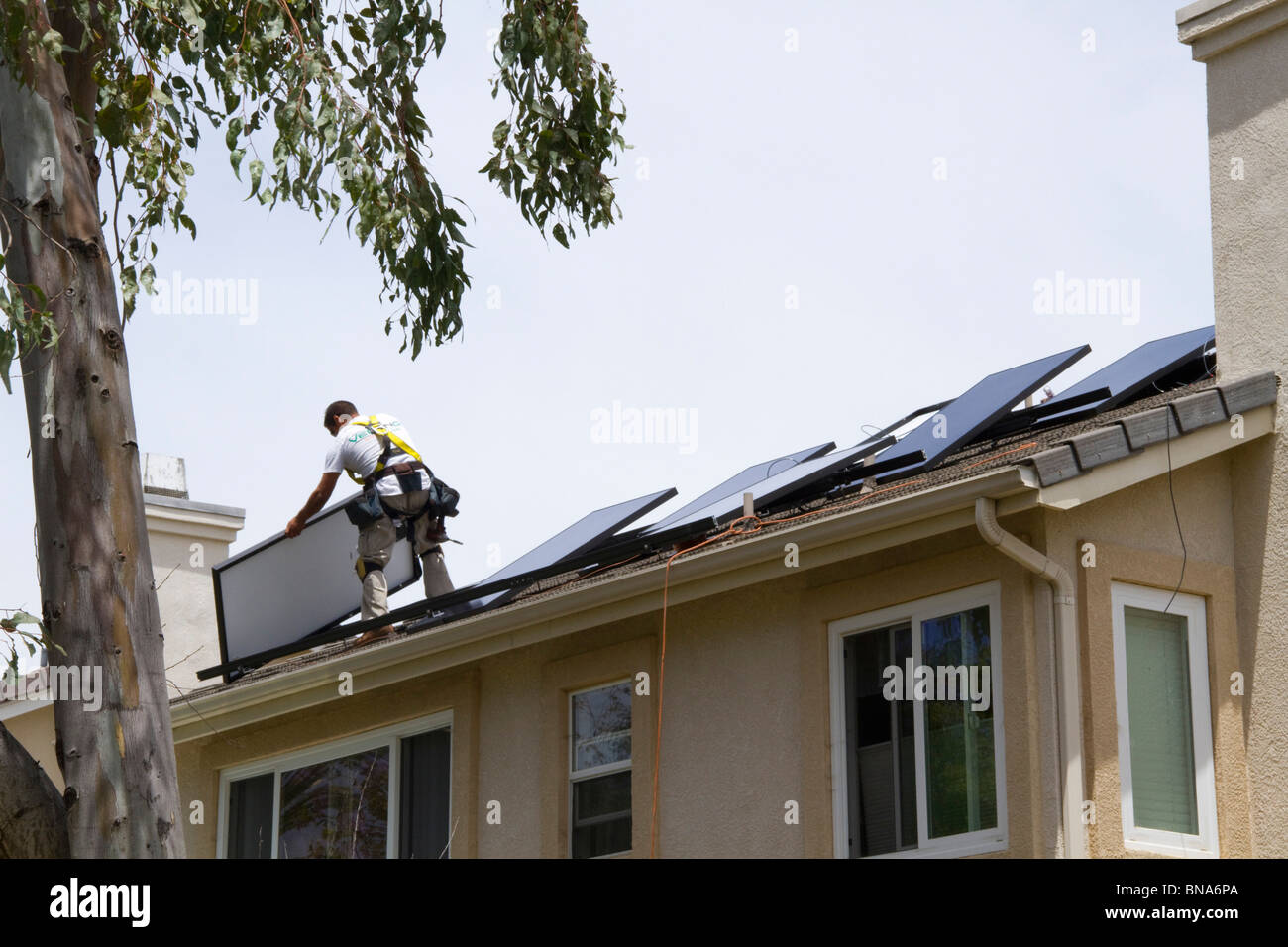 solar power clean green energy panel roof home house generate electricity save conserve sun install installation new Sunpower Stock Photo