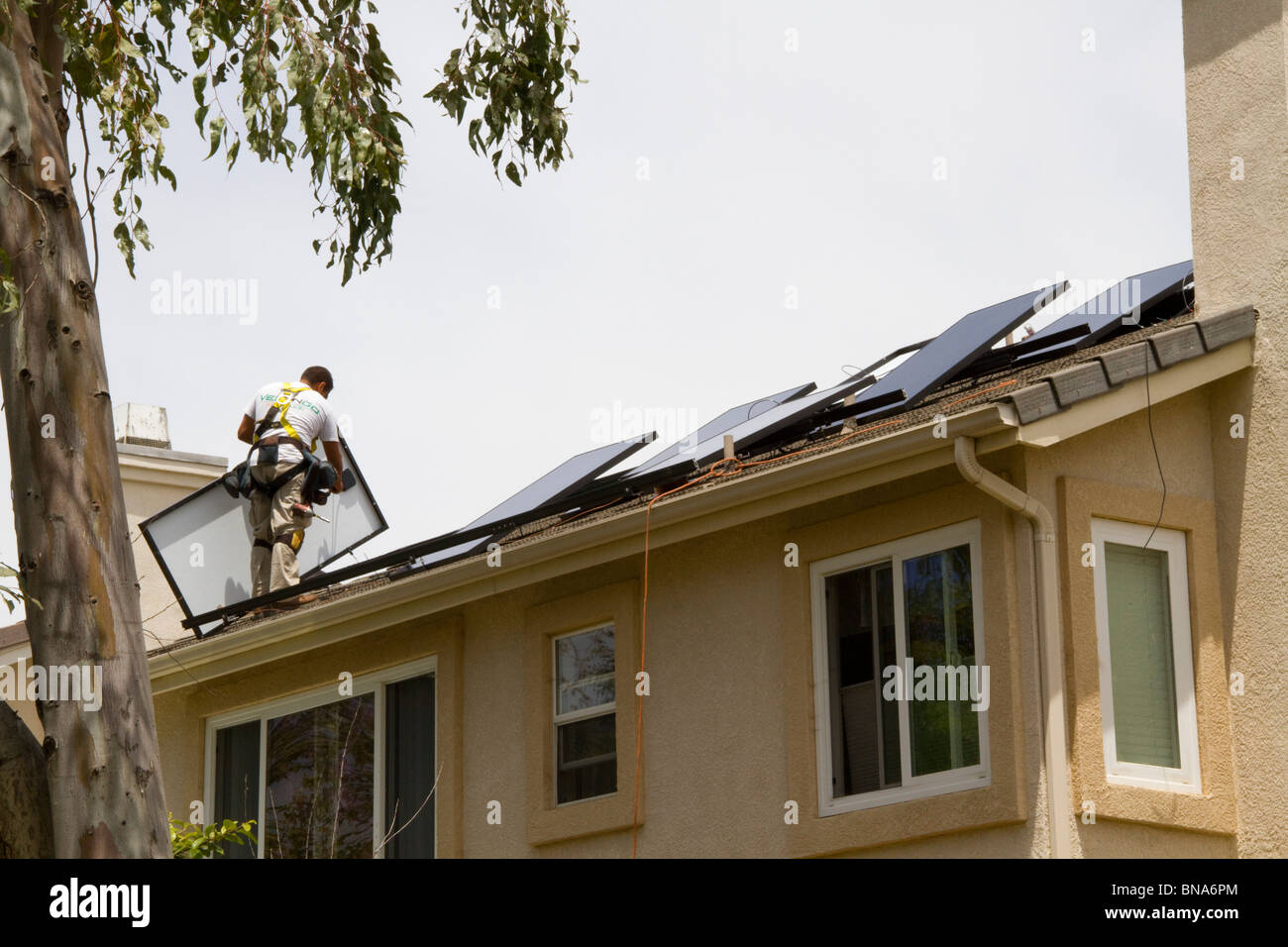 solar power clean green energy panel roof home house generate electricity save conserve sun install installation new Sunpower Stock Photo