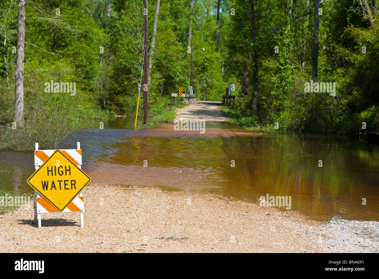 Abita Springs, LA - Mar 2009 - Sign warns of high water on flooded roads in rural Abita Springs, Louisiana Stock Photo