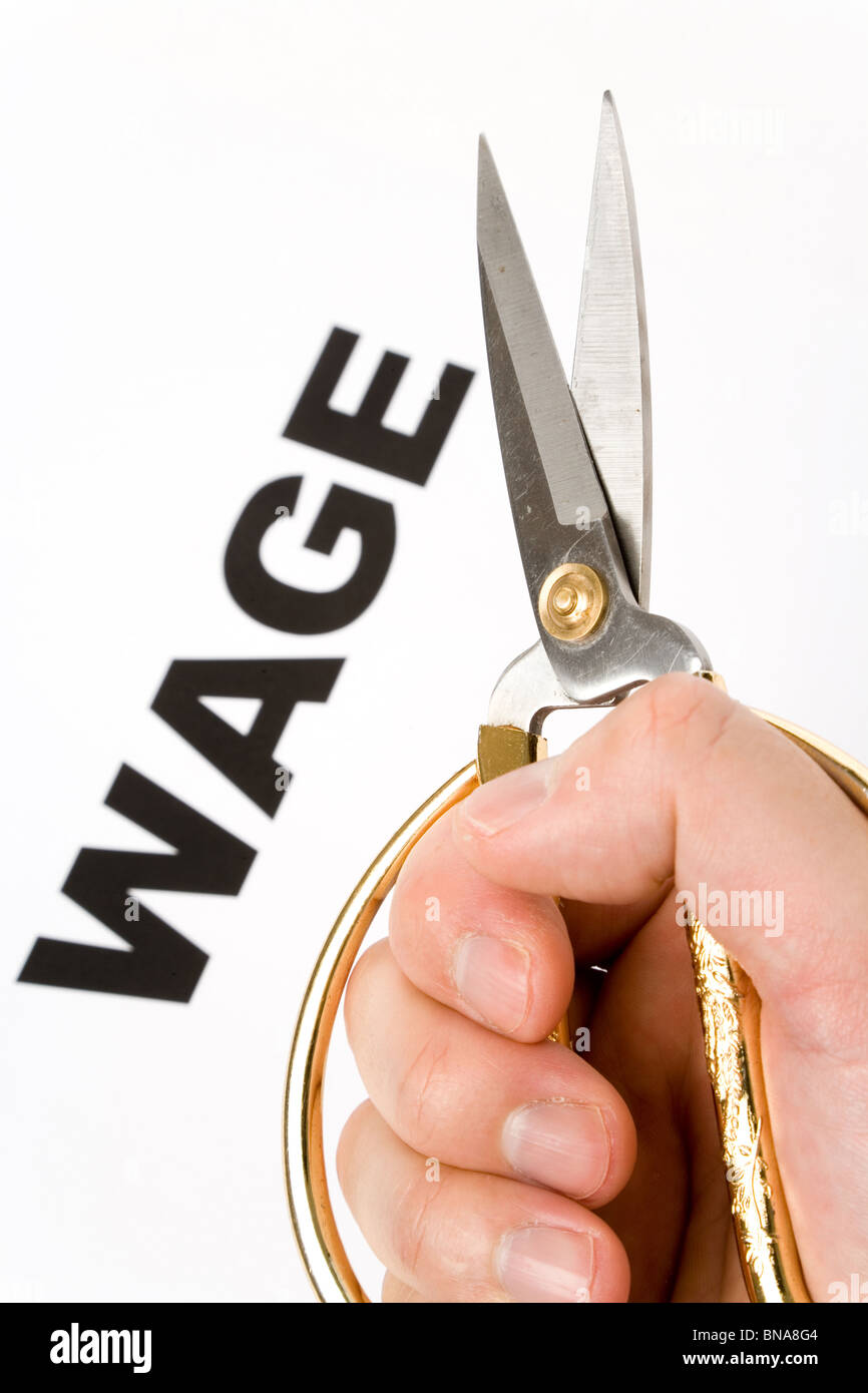 text of wage and scissors, concept of salary cut Stock Photo