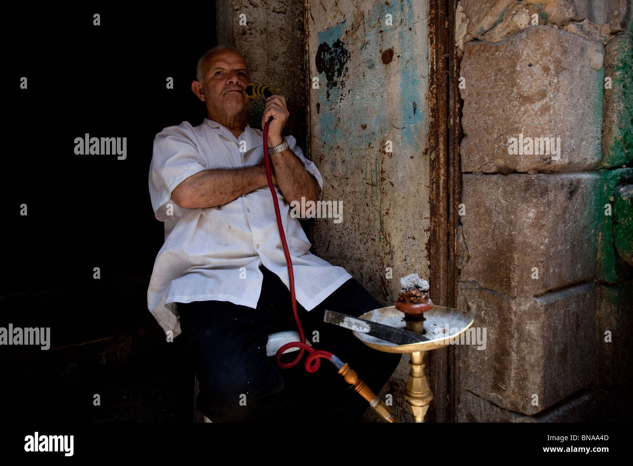 A Palestinian man smoking hookah pipe in the old city East Jerusalem Israel Stock Photo