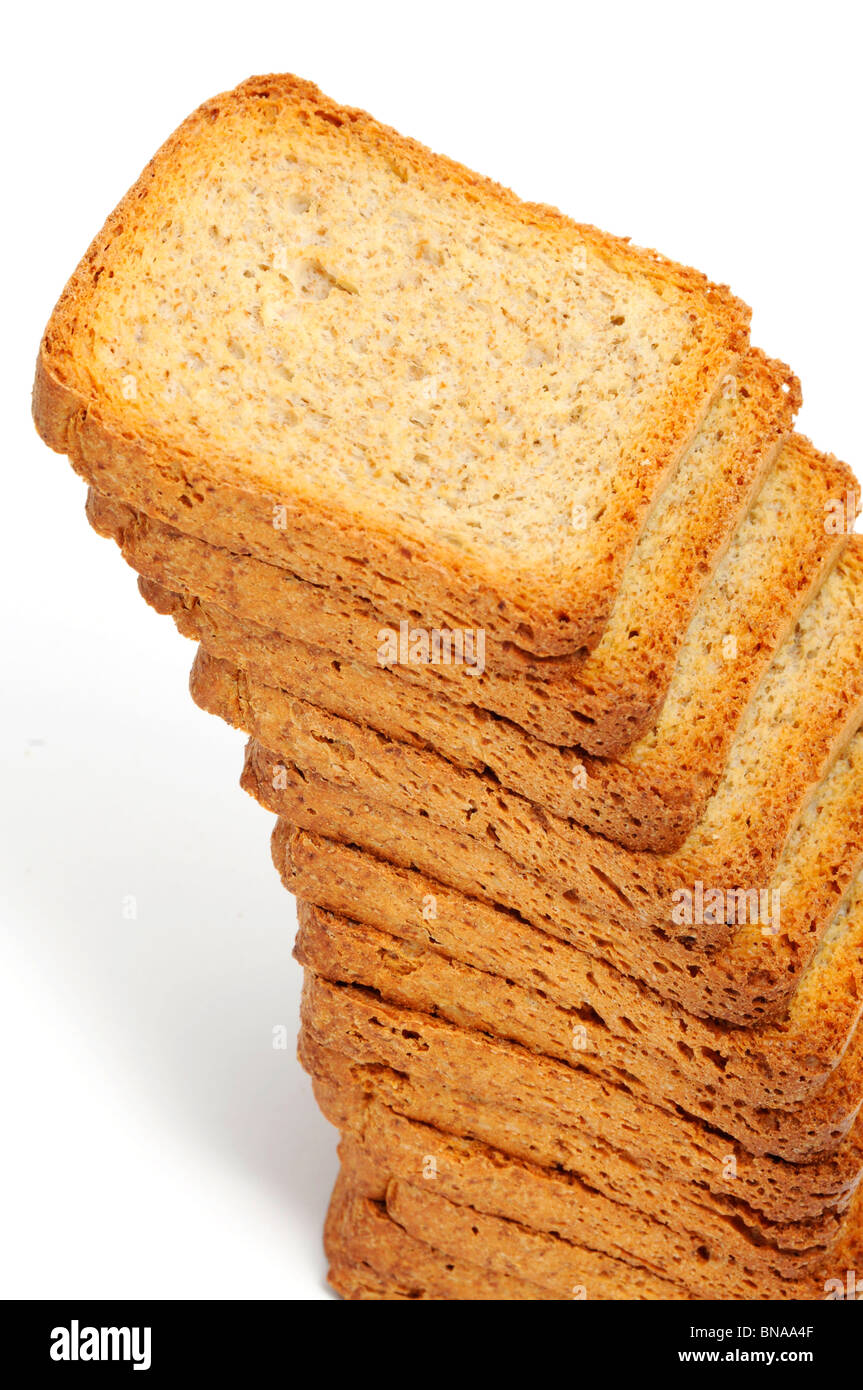 a pile of brown bread rusks on a white background Stock Photo - Alamy
