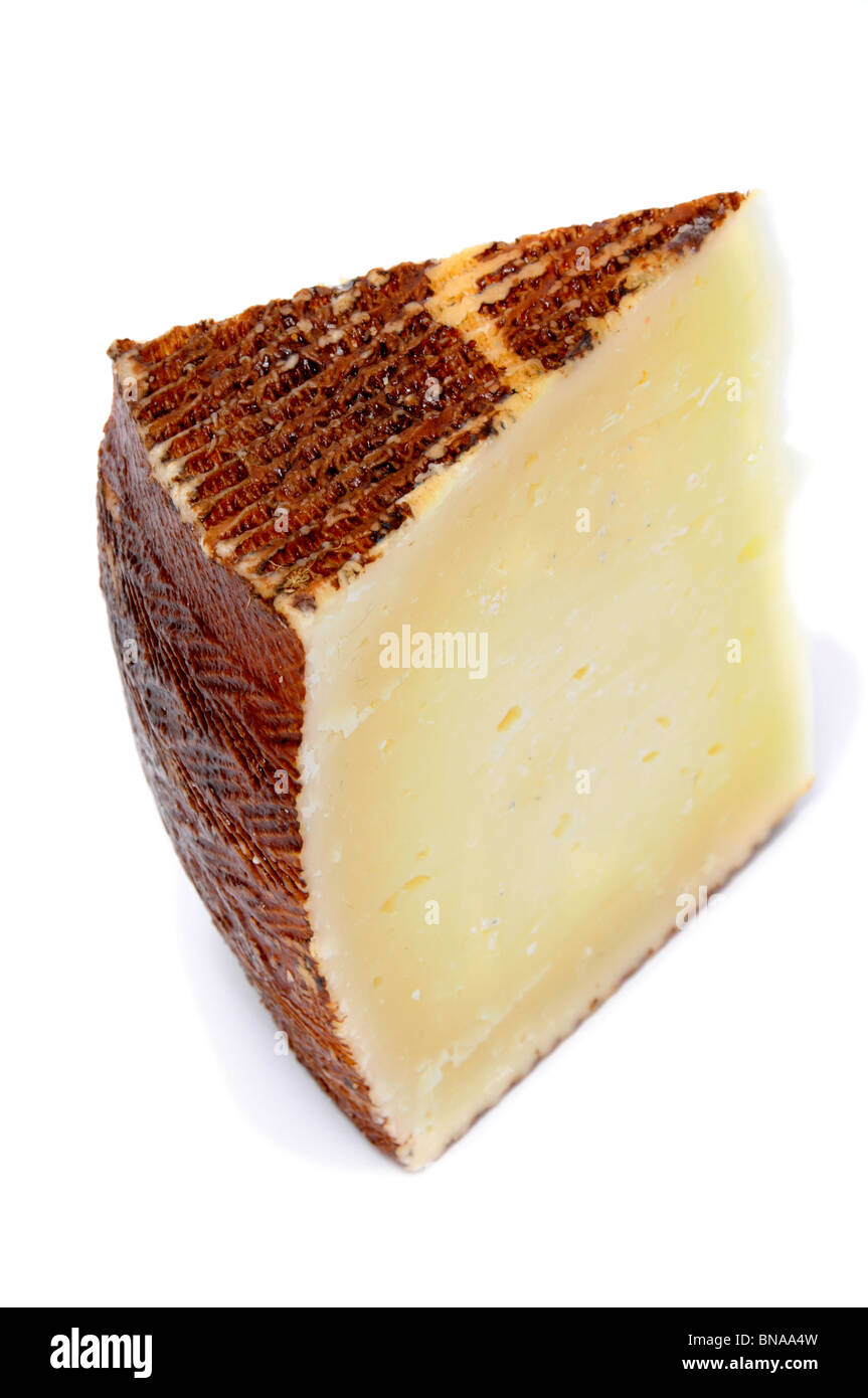 a piece of manchego cheese on a white background Stock Photo Alamy