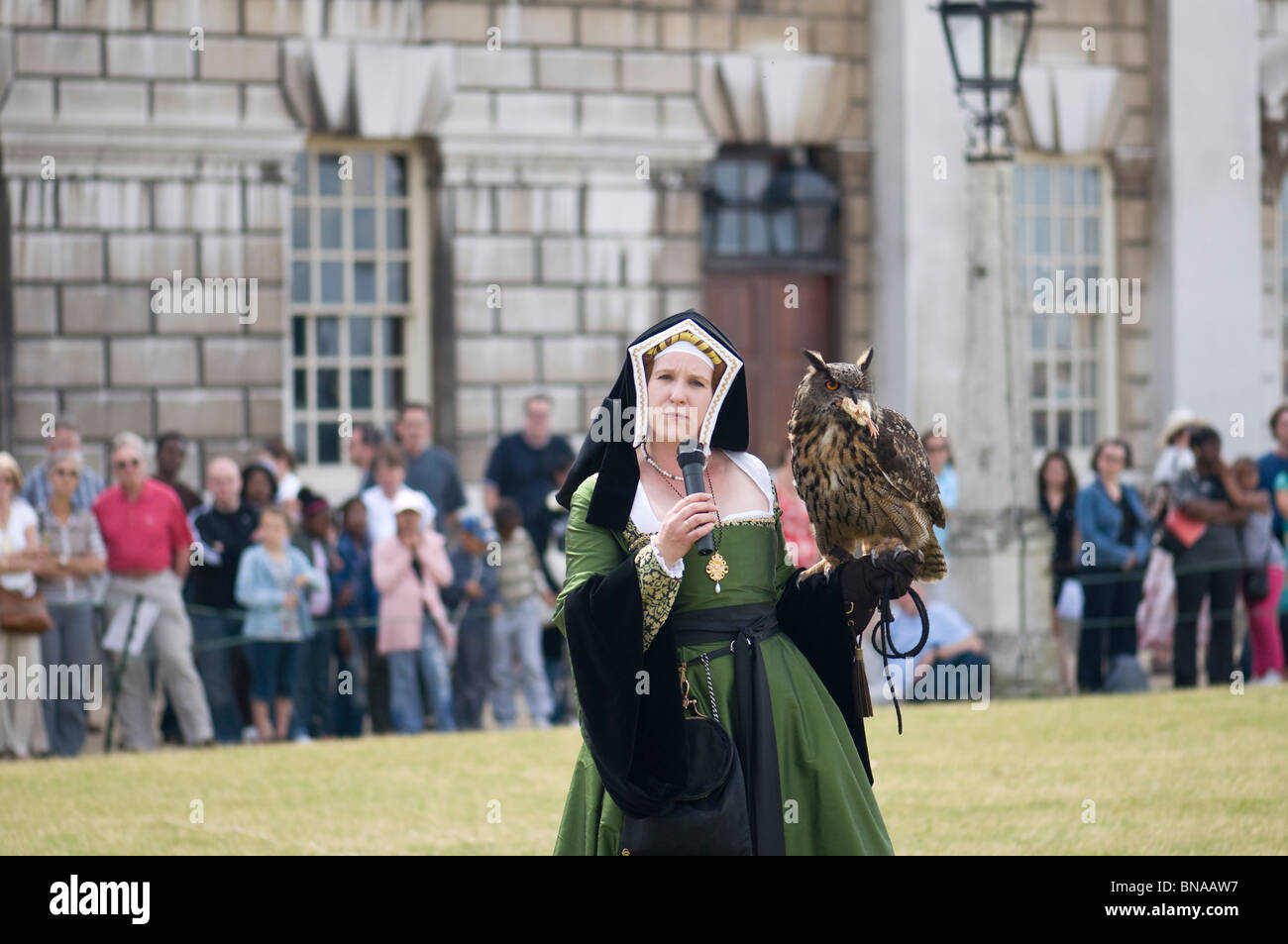 A woman with an owl during a falconry show Stock Photo