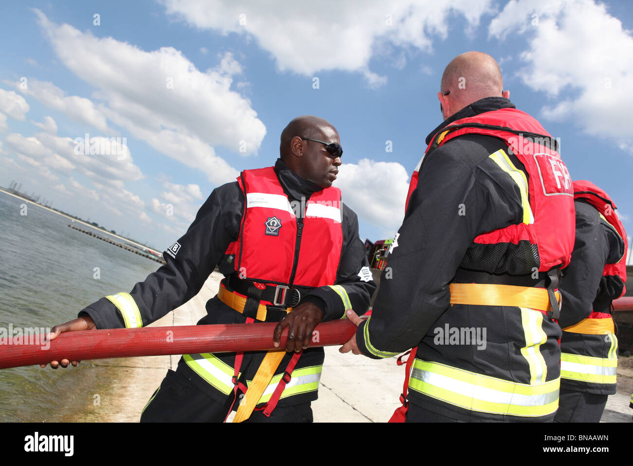 fireman training to save a person who is drowning in open water. they ...