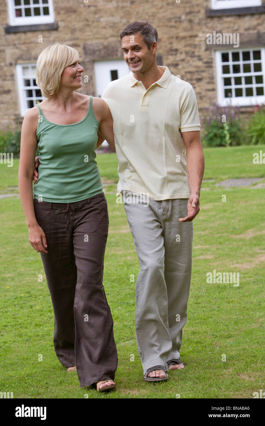 Couple in conversation, walking Stock Photo