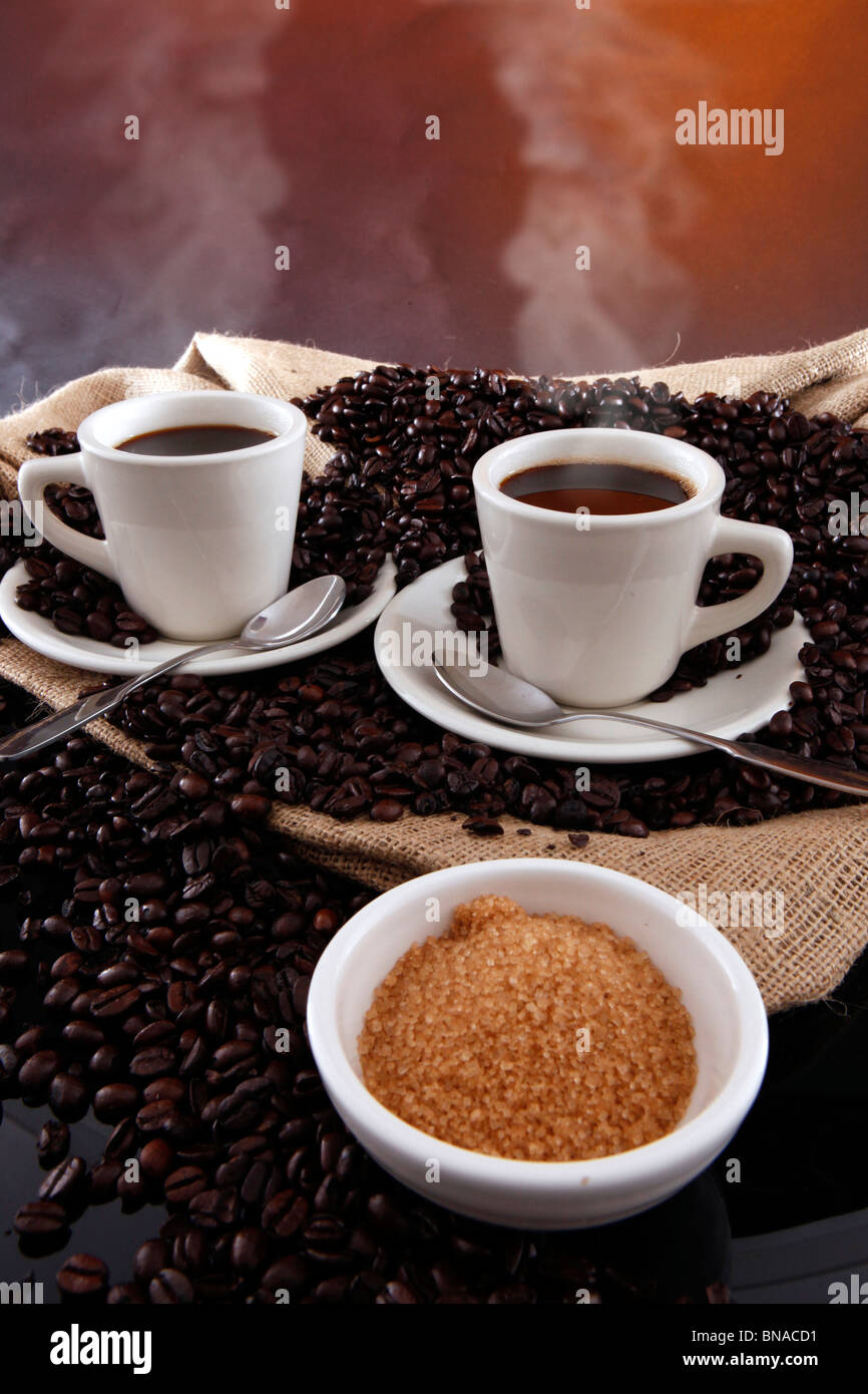 2 cups of fresh brewed coffee and coffee grains from a sisal sack Stock