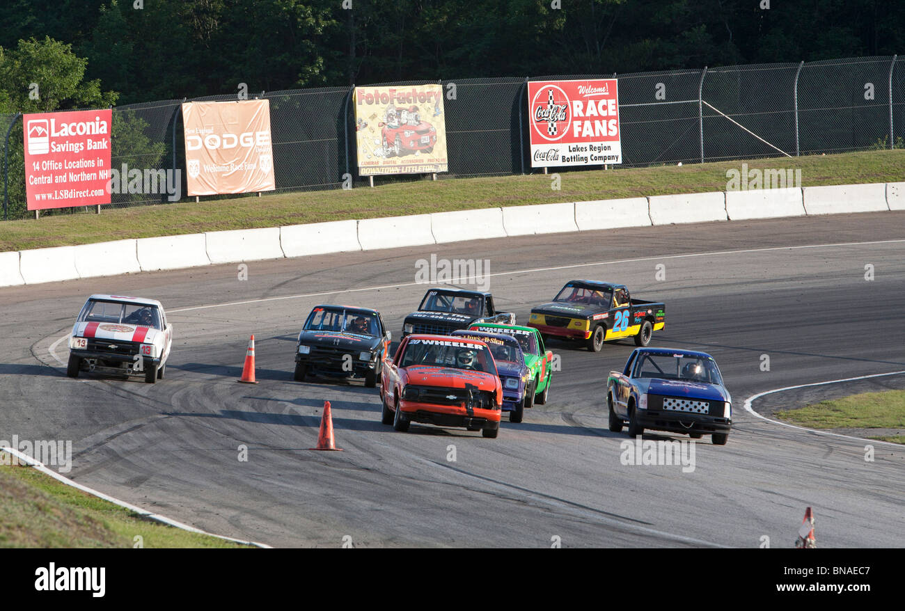 Children and Teens Drive Trucks in Stock Car Race Stock Photo