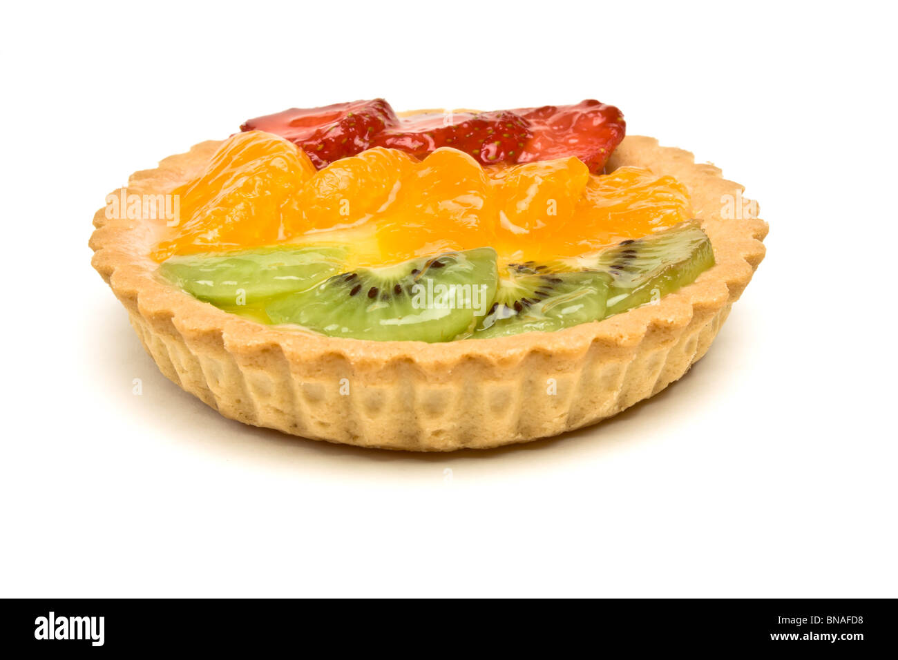 Custard filled tart topped with summer fruits of Strawberry, mandarin orange and kiwi fruit. Stock Photo