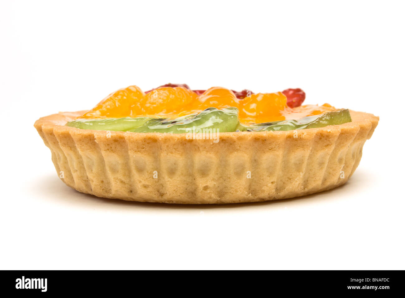 Custard filled tart topped with summer fruits of Strawberry, mandarin orange and kiwi fruit. Stock Photo