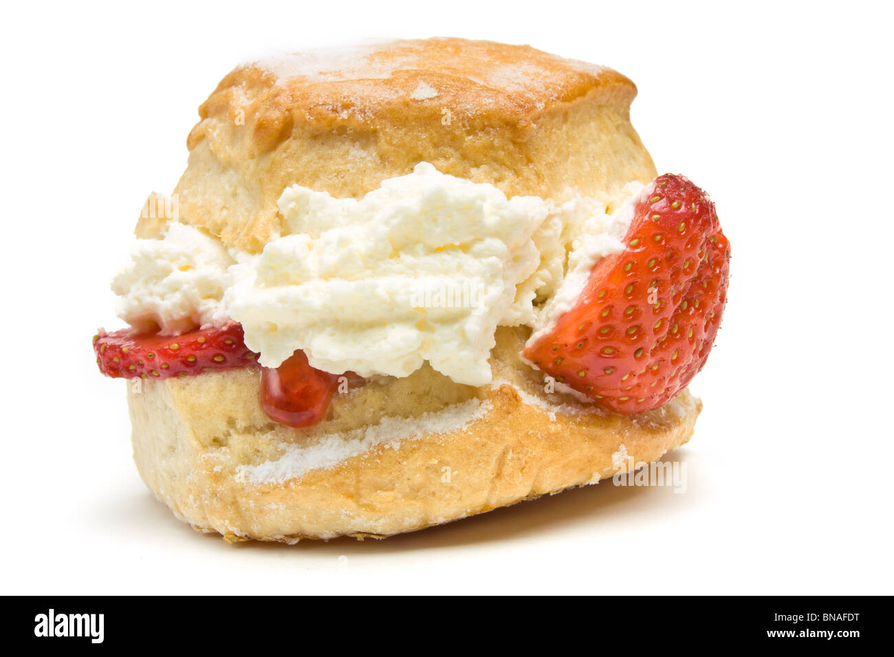Cream Scone with strawberry from low perspective isolated against whitebackground. Stock Photo