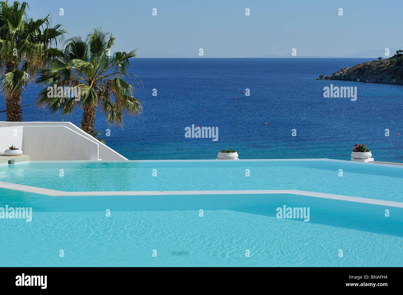 Mykonos. Greece. Infinity pool at Hotel Mykonos Blu, Psarou Beach. Stock Photo