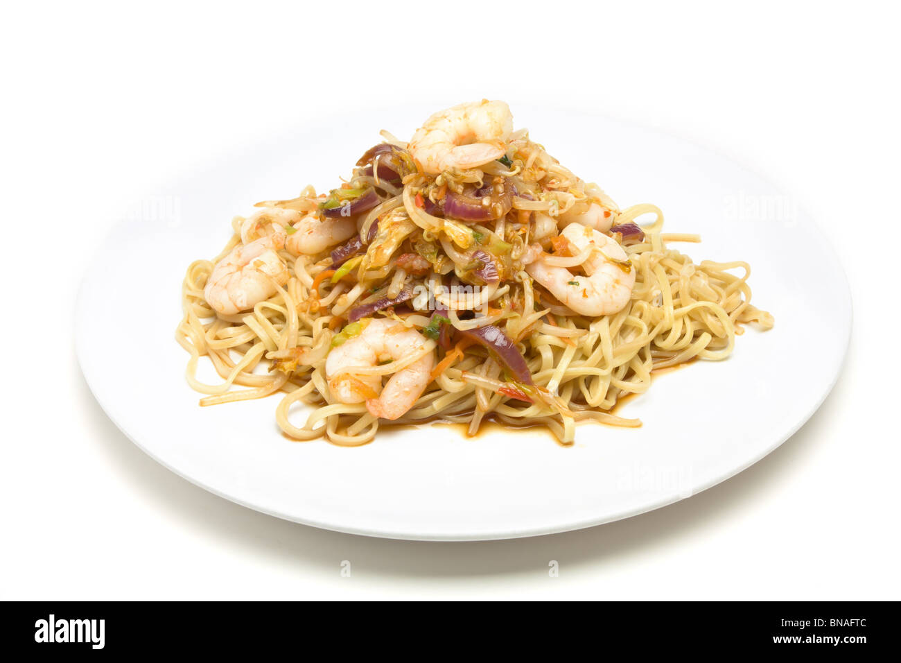 Prawn Stir fry on white plate isolated against white background. Stock Photo