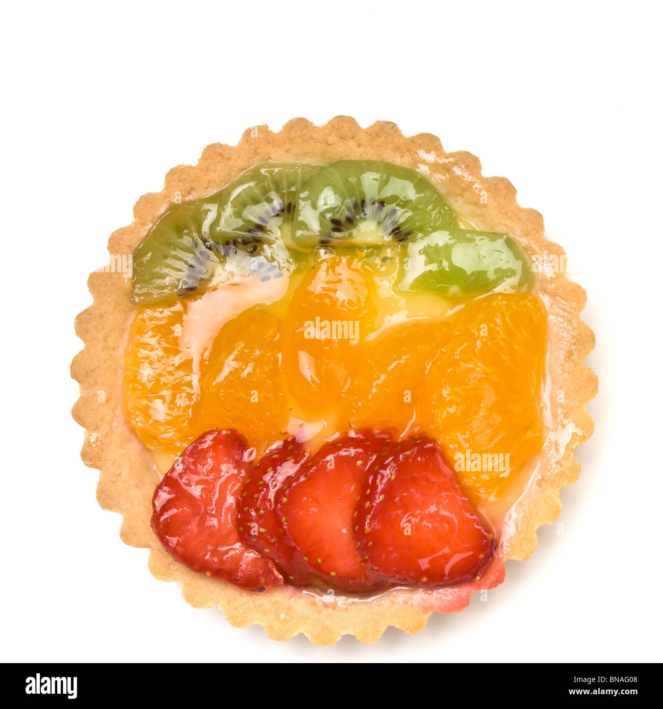 Custard filled tart topped with summer fruits of Strawberry, mandarin orange and kiwi fruit. Stock Photo