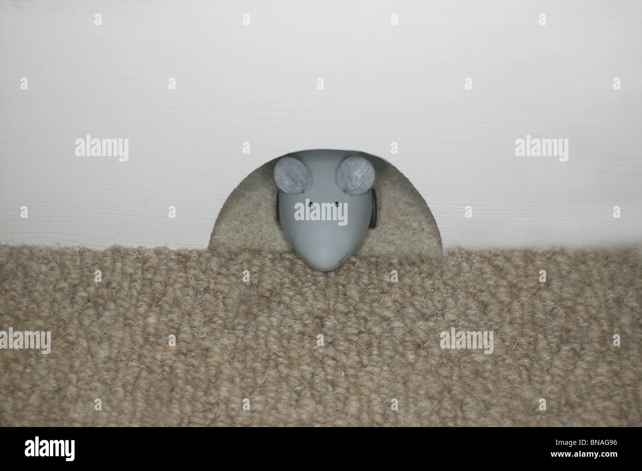 Toy mouse at hole Stock Photo Alamy