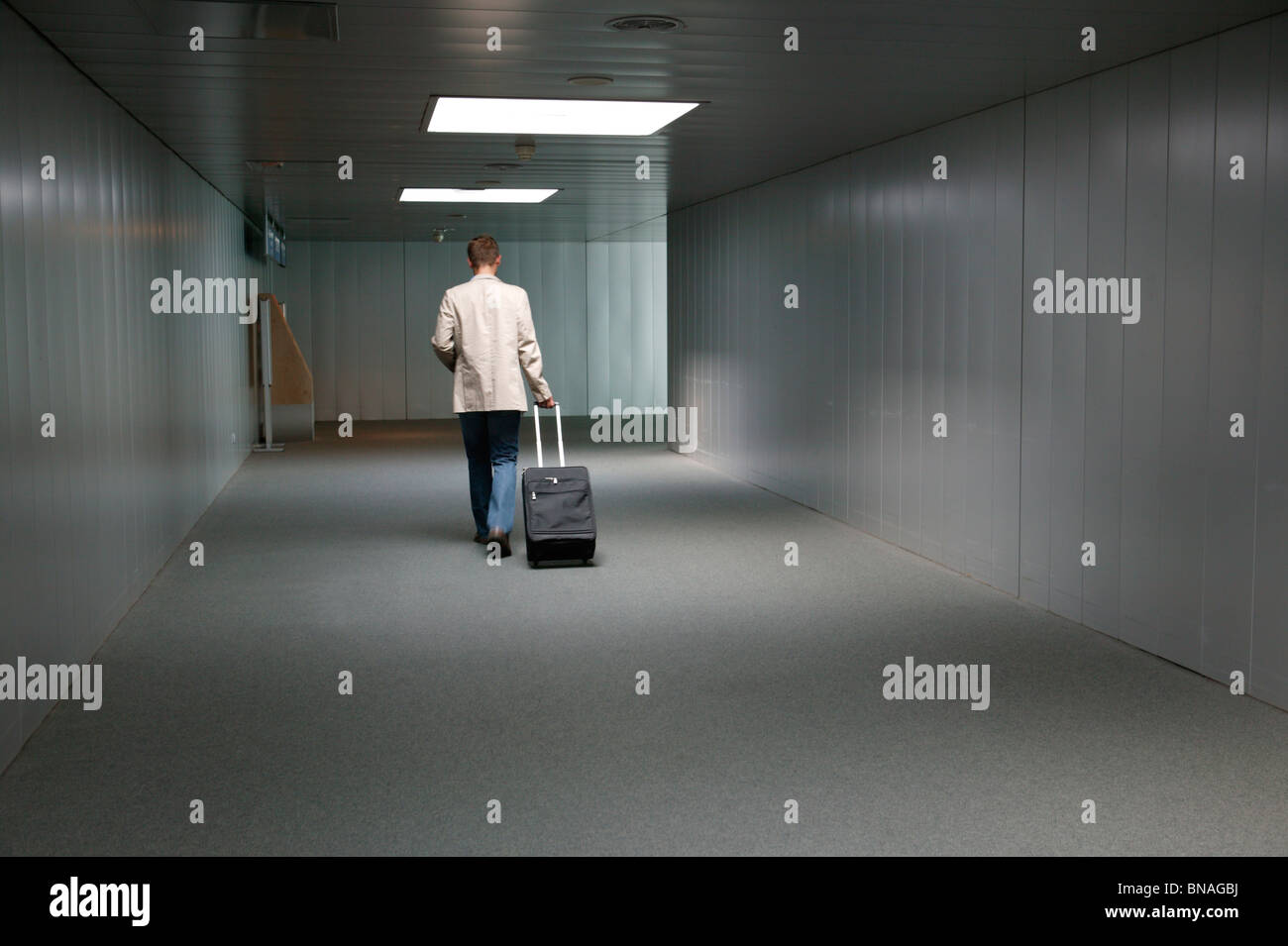 Man walking with trolley case Stock Photo - Alamy