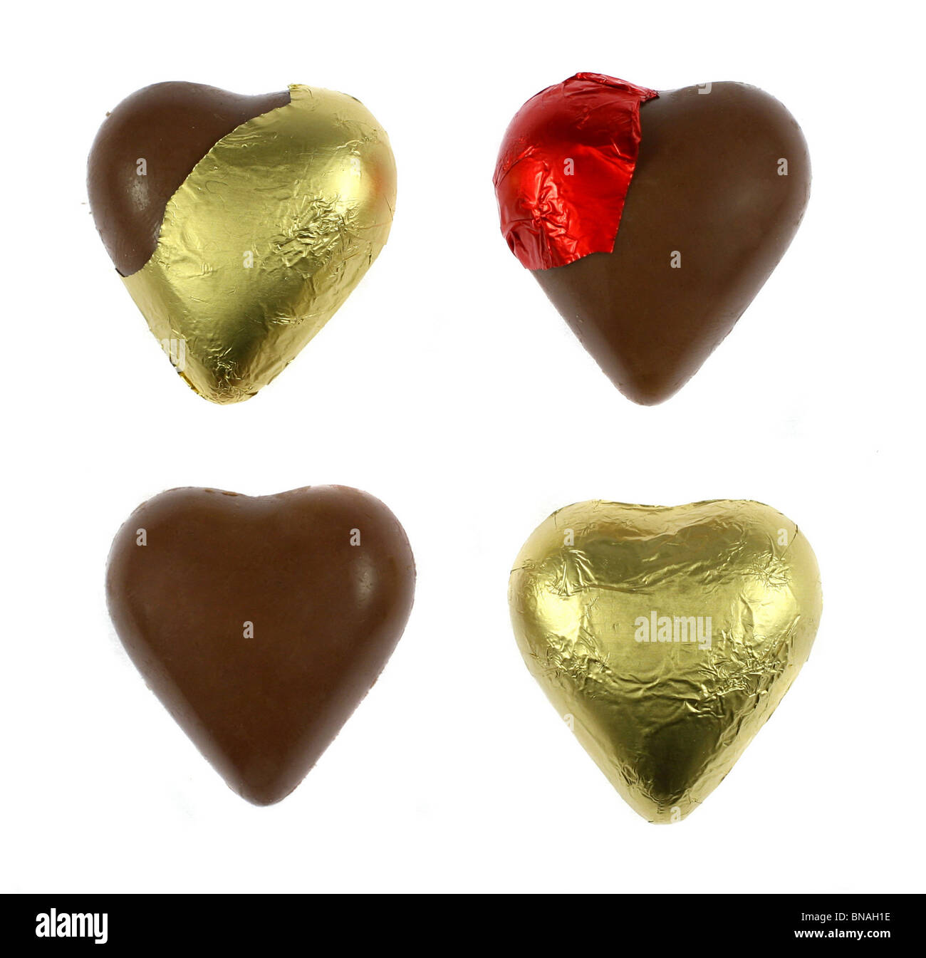 Wrapped and unwrapped chocolate hearts isolated on white Stock Photo