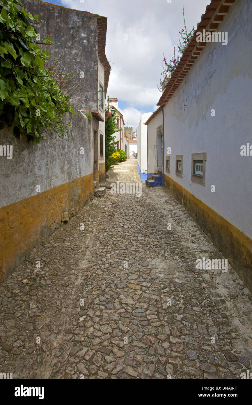 Medieval Cobblestone Street of the Fortified Village of Obidos Stock Photo