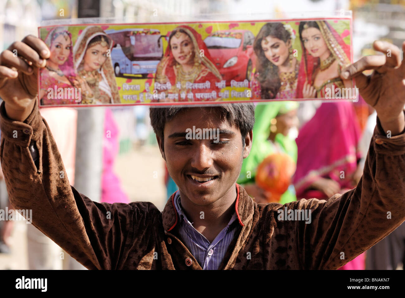 A Boy selling bollywood stars poster of Indian cinema at Pushkar fair, Rajasthan, India. Stock Photo