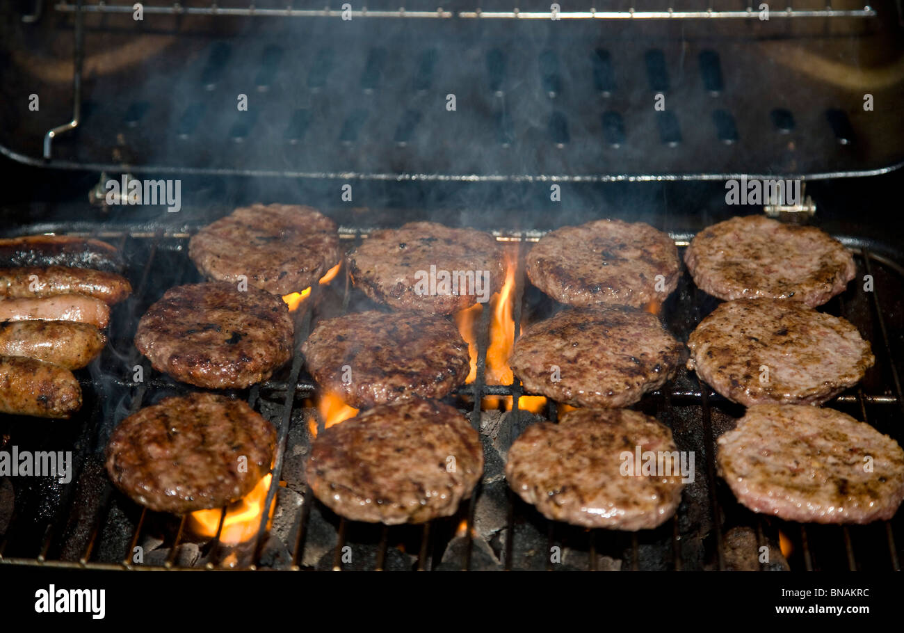 Burgers and sausages grilling on a BBQ Stock Photo Alamy