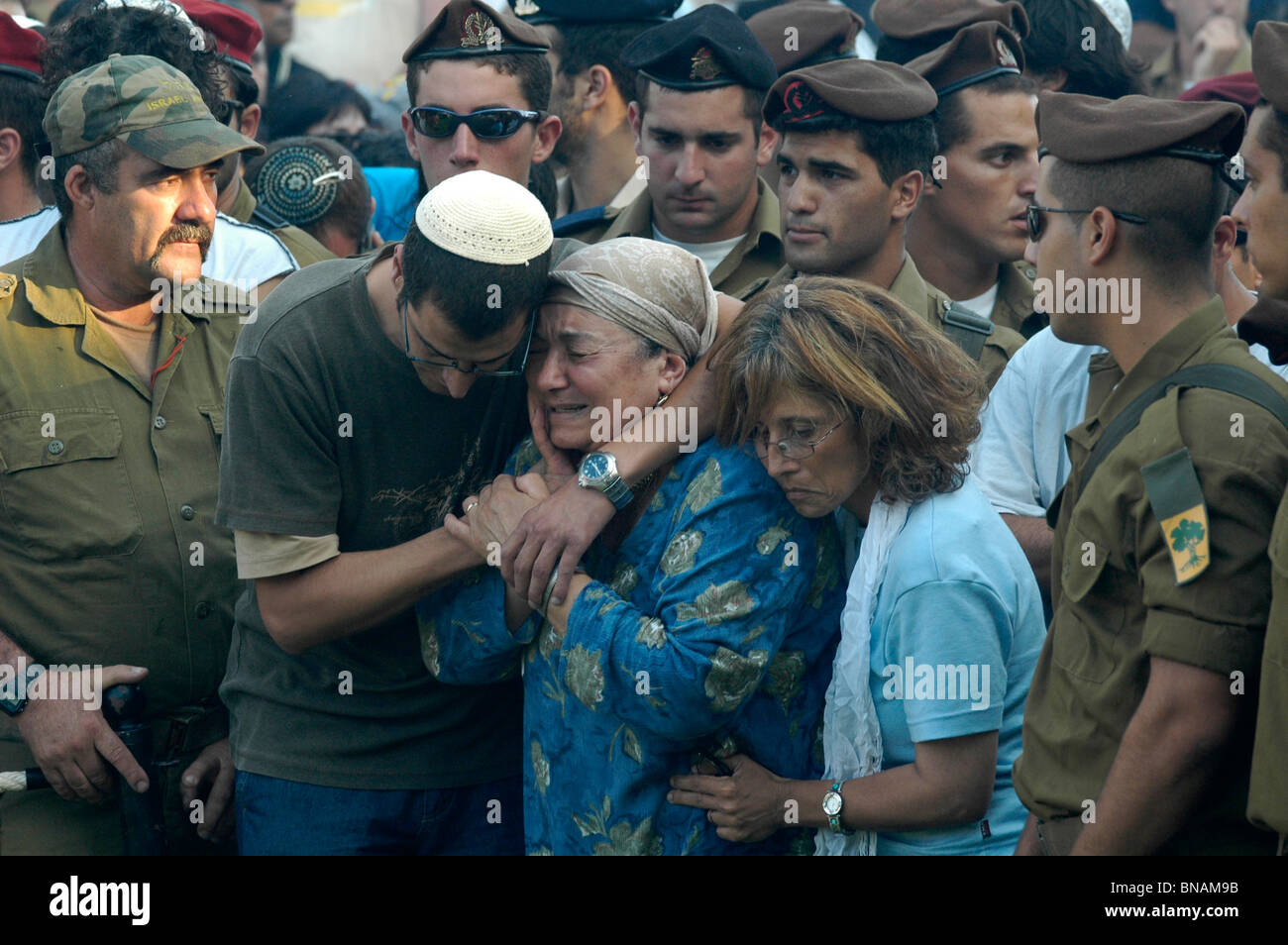 Relatives of Israeli soldier from the Golani brigade killed by Hezbollah in Lebanon during the  Israel - Hezbullah war comfort each other during a funeral in the city of Safed northern Israel Stock Photo