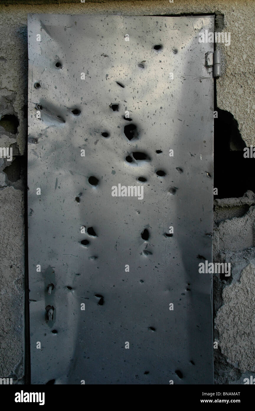 A door in a house shows shrapnel damage from a rocket fired by Hezbollah a Lebanese Islamist militant group in the Druze village of Horfesh northern Israel Stock Photo