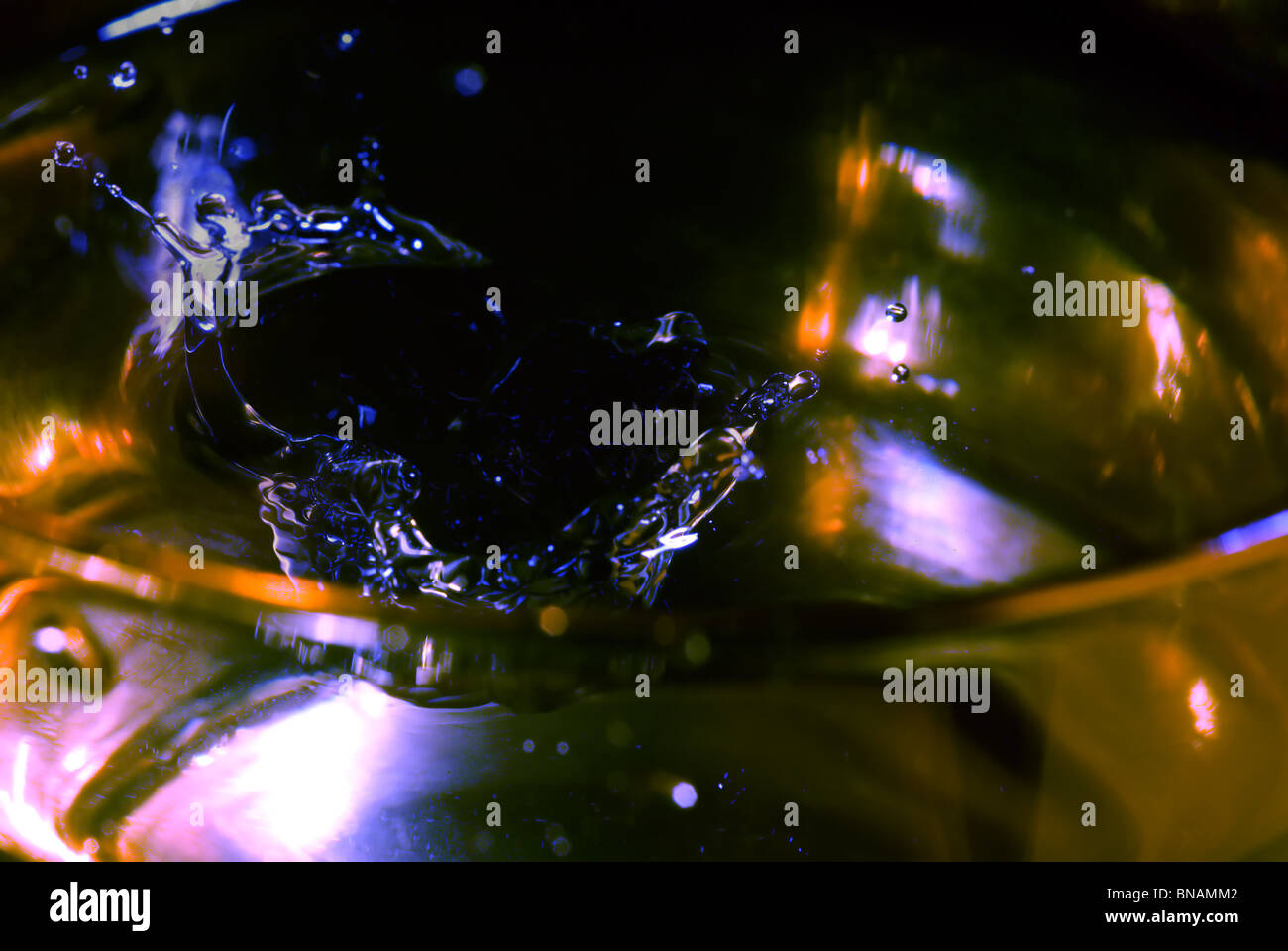 splash on clear glass with colored light Stock Photo - Alamy