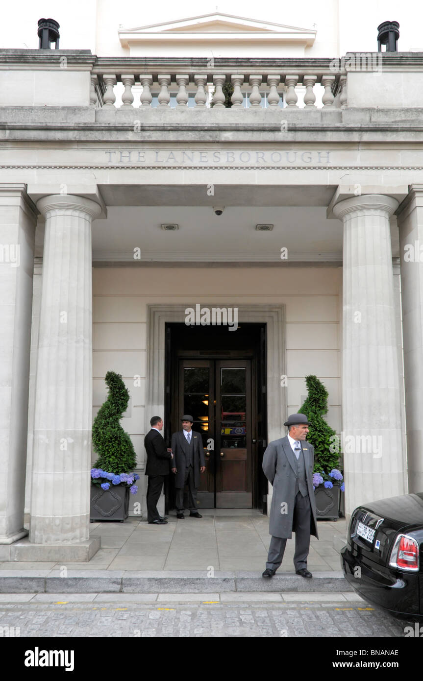 Hyde Park Corner hotel doorman or porter outside Knightsbridge entrance doors sign above Lanesborough luxury five star hotel Central London England UK Stock Photo