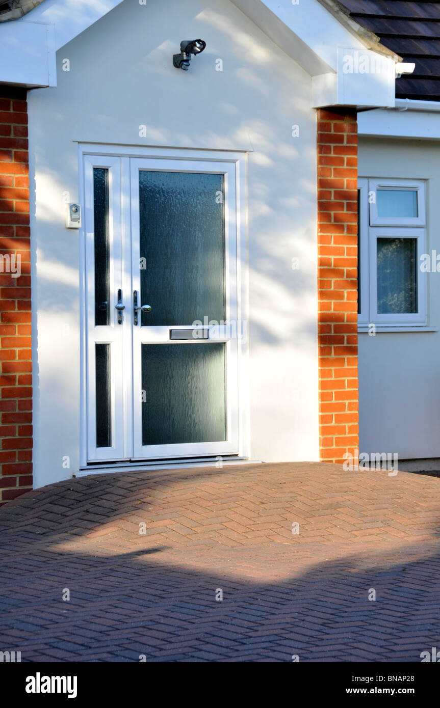 Block paving disability ramp to house front door giving step free access for disabled wheelchair user Essex England UK Stock Photo