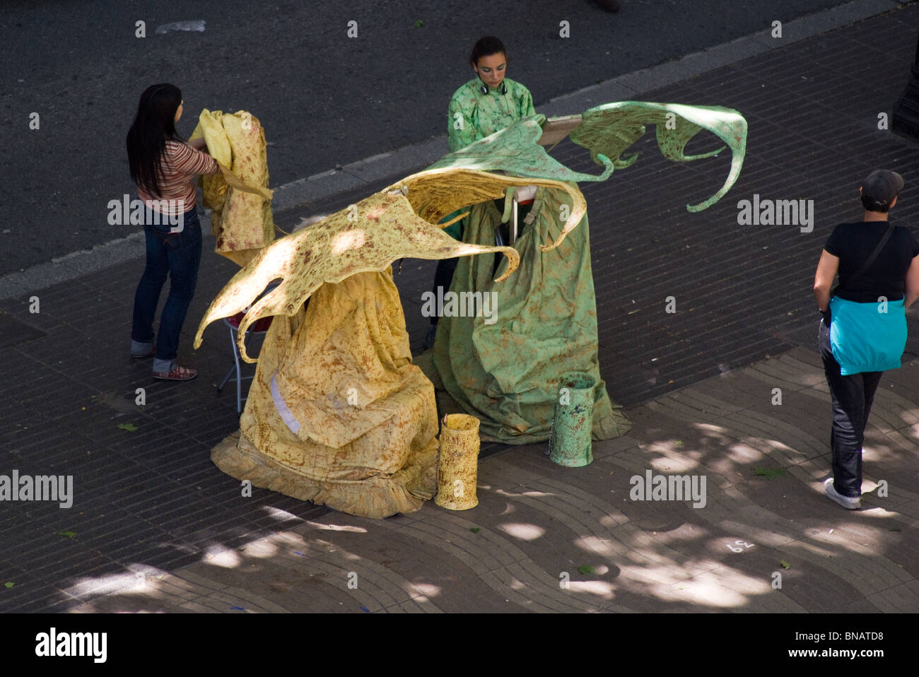 TWO FANCY DRESS  FAIRY HUMAN STATUES STREET ARTISTS GETTING READY ON LAS RAMBLAS BARCELONA SPAIN Stock Photo