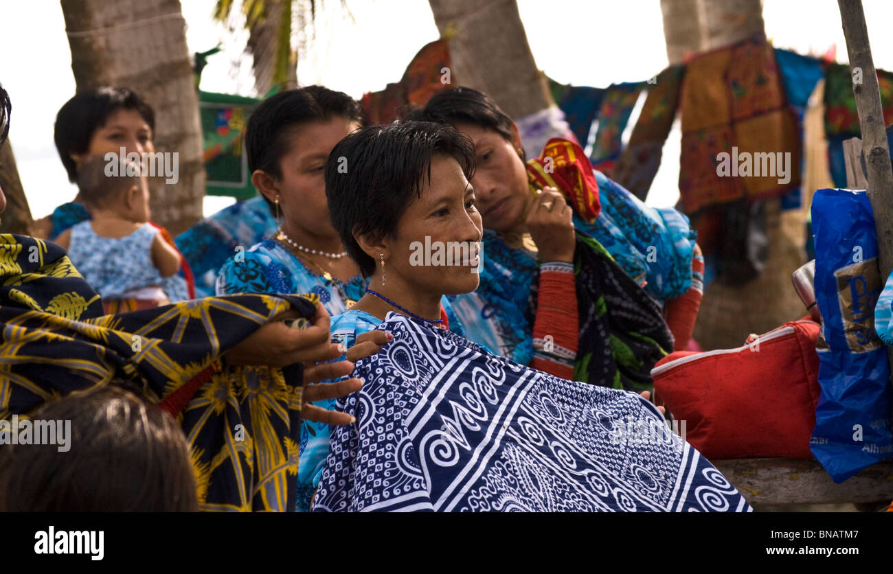 Kuna Indian women showing their painstakingly hand crafted molas to tourists, hoping for a sale. Stock Photo
