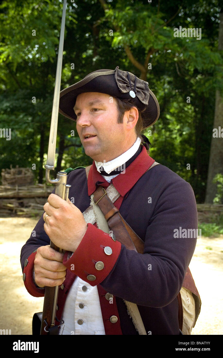 A costumed interpreter describes the life of a Continental Army soldier at Yorktown Victory Center, a living history museum in Yorktown, Virginia, USA. Stock Photo