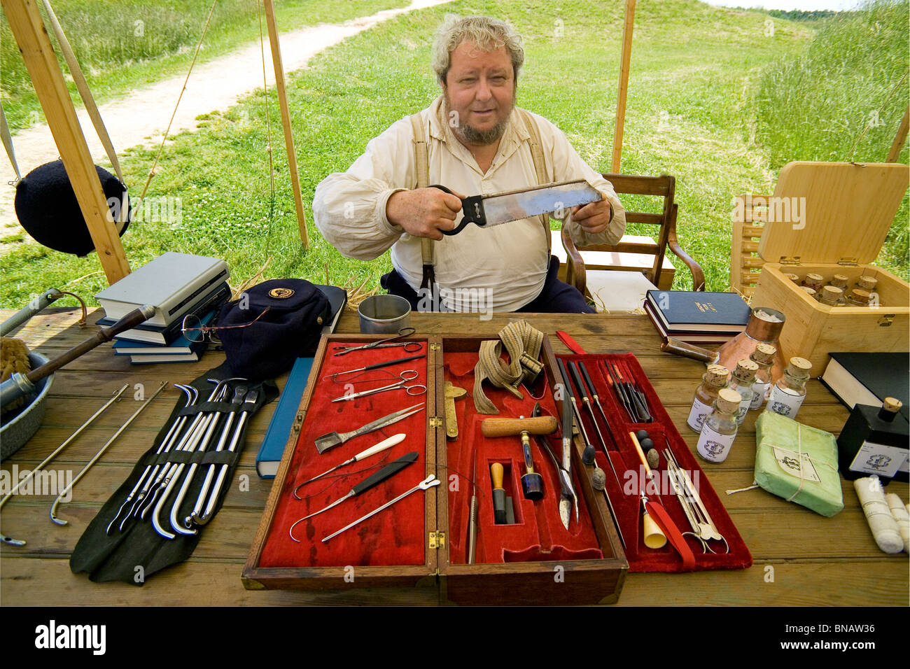 A reenactor displays Civil War medical instruments at a re-created military encampment at Yorktown Battlefield in historic Yorktown, Virginia, USA. Stock Photo