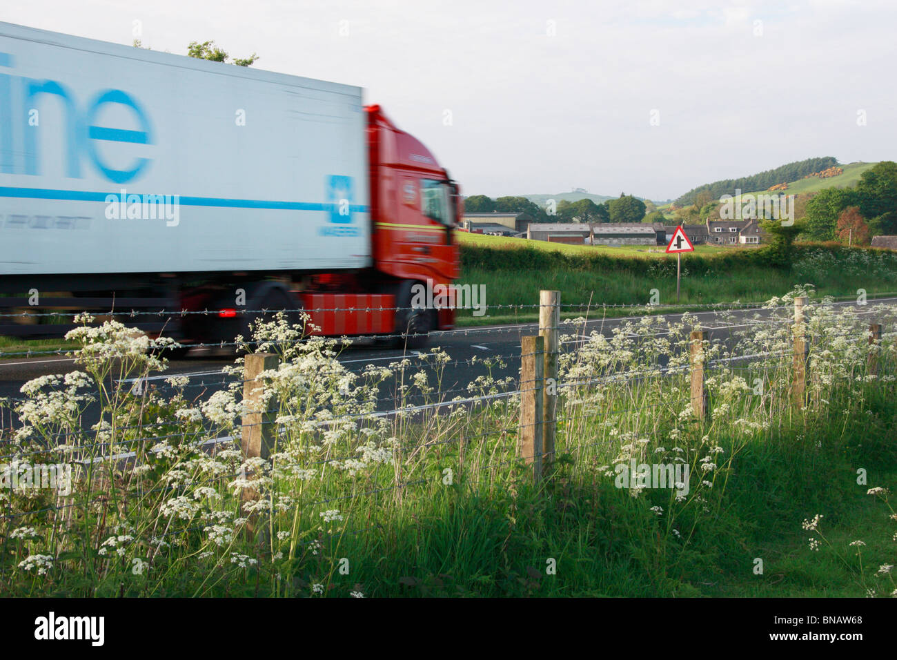 Blurred moving lorry on A75 road in Dumfries and Galloway, Scotland